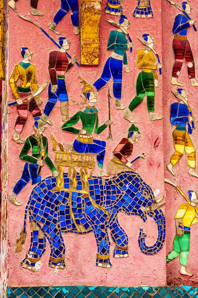 Laos- Luang Prabang. Mosaic mural depicting a man riding an elephant